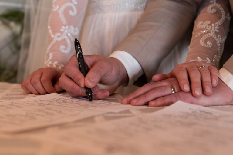 a bride and groom signing their wedding vows