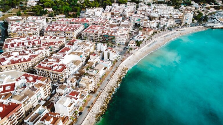 an aerial view of a city next to the ocean
