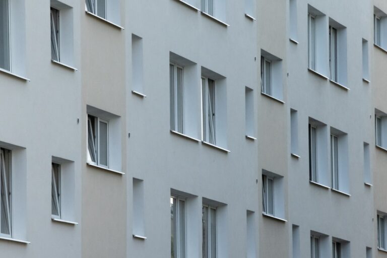 white concrete building with glass windows