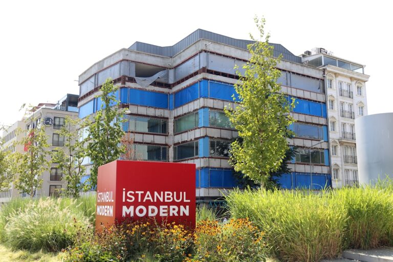 A large building with a red sign in front of it