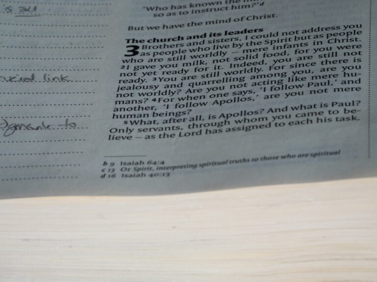 A close up of a newspaper with a clock on it