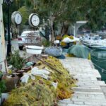 yellow fishing net in river bank with moored boats